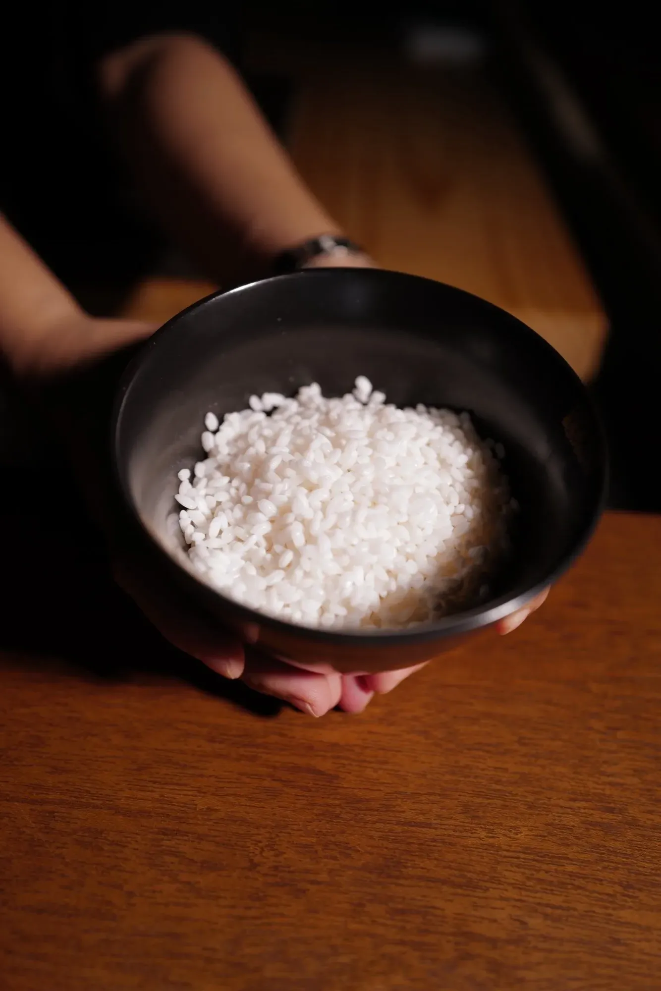 A bowl of Niigata rice, held